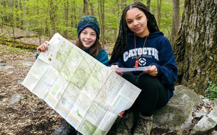 two girls practice navigation skills on a trip with outward bound